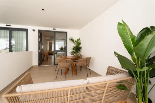 a living room with a couch and a table at Hotel Apartamentos Hamus in Conil de la Frontera