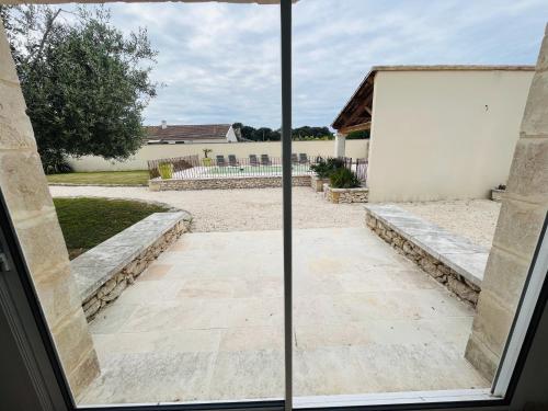 a view from a window of a patio at Le Mas de Maellou - Maison de vacances en Drôme Provençale in Grillon