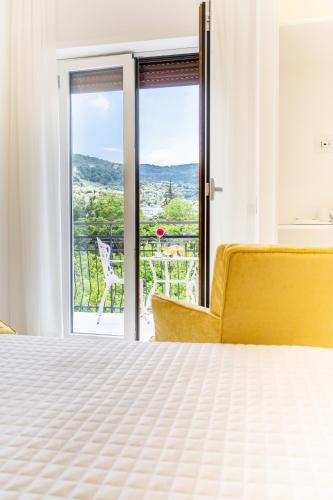 a bedroom with a bed and a window with a view at L'INCANTO DI CIOFFI ROOMS in Sorrento