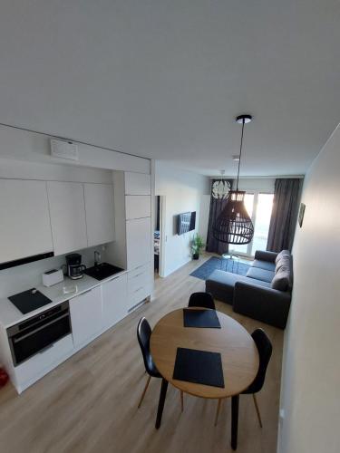 a kitchen and a living room with a table and a couch at Snow Queen's residence in Rovaniemi