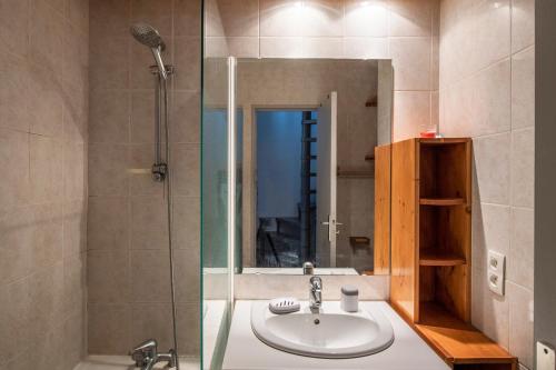a bathroom with a sink and a shower with a mirror at Chamonix Sud - Balme 402 Duplex - Happy Rentals in Chamonix