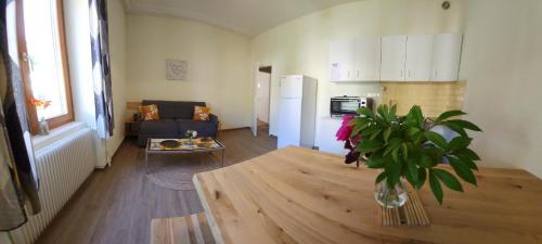 a living room with a table and a kitchen at Gîte Jonquille, 2 à 8 personnes avec salle de jeux et SPA dans la résidence in Ventron