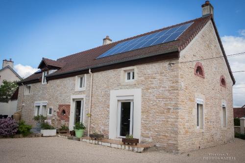 a house with solar panels on the roof at Aux Mésanges in Labergement-Foigney