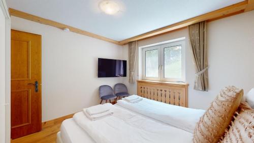a hotel room with a bed and a window at Cosy apartment surrounded by nature in Varen - Salgesch region in Varen