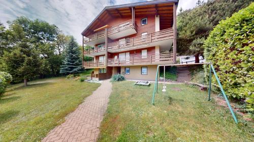 a large apartment building with a pathway in front of it at Cosy apartment surrounded by nature in Varen - Salgesch region in Varen