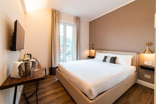 a hotel room with a bed and a window at Hotel del Conte in Laveno-Mombello