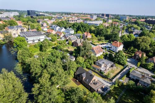 an aerial view of a town with a river and houses at Lake House Central Lyngby in Kongens Lyngby