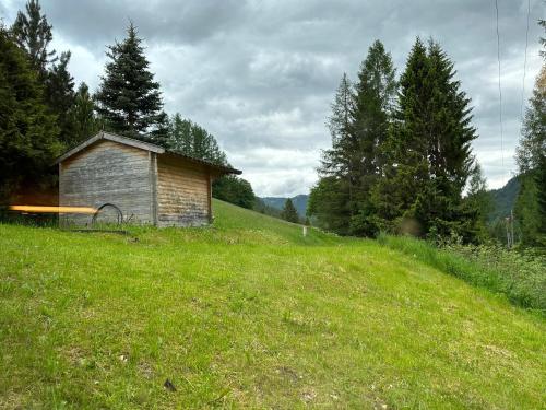 a small building on a hill in a field at Appartment Rosennock in Sankt Oswald