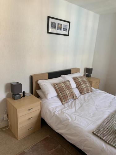 a bedroom with a bed and a night stand with a television at 16 Main Street in St Bees