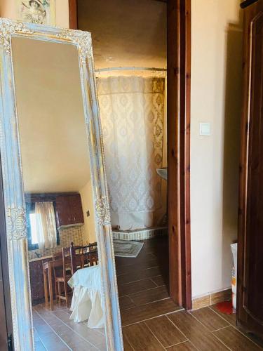a mirror in front of a room with a table at Villa La dame blanche in Skala Potamias