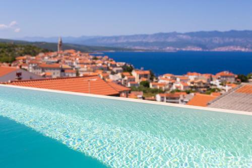 a view of a city from the edge of a swimming pool at Villa Bella Vista in Vrbnik