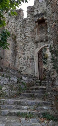 an old brick building with stairs and a doorway at Stone Clock's House in Nafpaktos