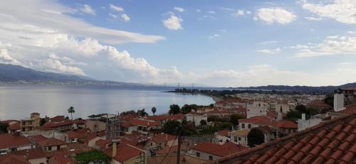 a view of a city and a river with buildings at Stone Clock's House in Nafpaktos