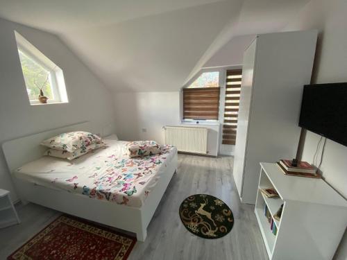 a small bedroom with a bed and a window at Vila Castelana in Caciulata