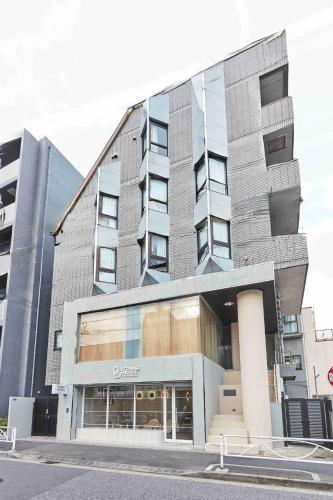 a building on a street in front of a building at Tora Hotel Asakusa in Tokyo