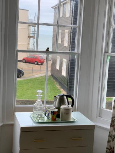 a kitchen counter with a window with a tea kettle on it at Vine Cottage - Sandgate in Sandgate