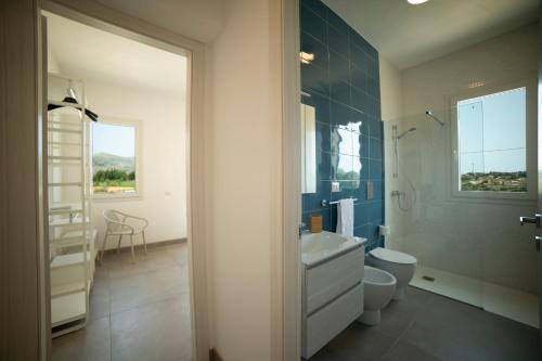 a bathroom with a white sink and a toilet at Scopello - Luxury Residence con piscina - 5 minuti dal mare in Castellammare del Golfo