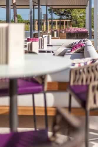 a row of tables with purple and white chairs at Domaine de Verchant & Spa - Relais & Châteaux in Montpellier