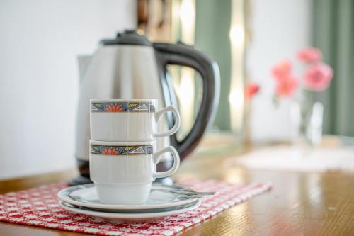 a couple of coffee cups sitting on a table at enJoy Appartements in Sankt Kanzian
