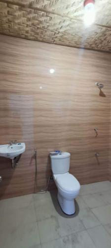 a bathroom with a toilet and a sink at Brigitte´s Rental House in Dauin