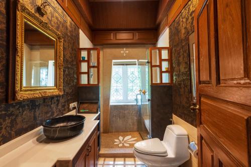 a bathroom with a sink and a toilet and a tub at Gala Beachfront Villa in Pattaya South