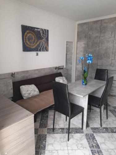 a dining room with a table and chairs at Villa Markos in Perissa