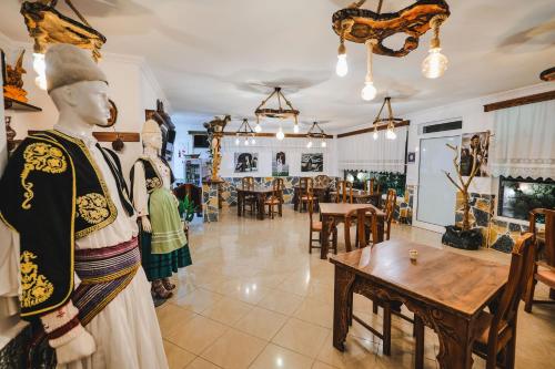 a shop with a mannequins and a table and chairs at Vila Ahmeti in Sarandë