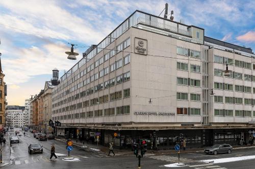 a large white building on a city street at Clarion Hotel Amaranten in Stockholm