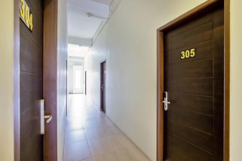 a hallway with a door with the number at Vivostay in Medan