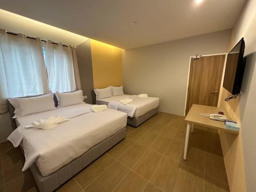 a hotel room with two beds and a television at A1 Hotel Sungai Petani in Sungai Petani