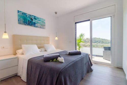 a bedroom with a bed with two pillows on it at Villa Luxury piscina y cascada 2 min de la playa in Lloret de Mar