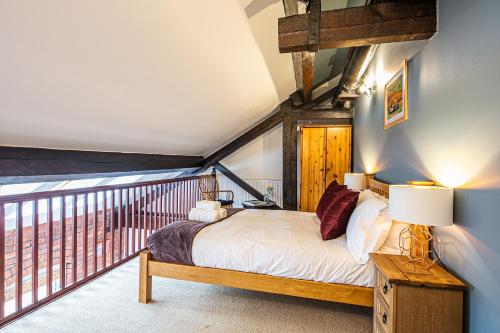 a bedroom with a bed and a balcony at Beautiful 1-Bed Apartment in Grade Listed Warehouse - Victoria Quays, Sheffield City Centre, FREE Parking, Pet Friendly, Netflix in Sheffield