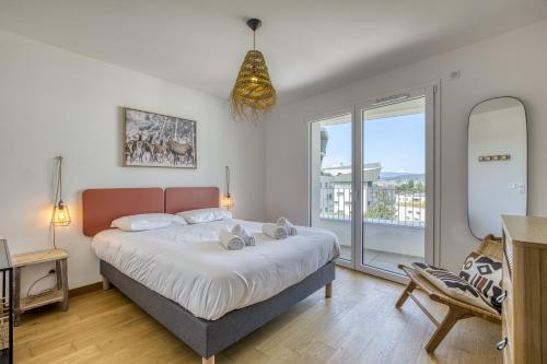 a bedroom with a bed and a large window at View point Paradise in Annecy