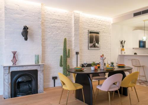 a living room with a table and chairs and a fireplace at Iturriza AC by Staynnapartments in Bilbao