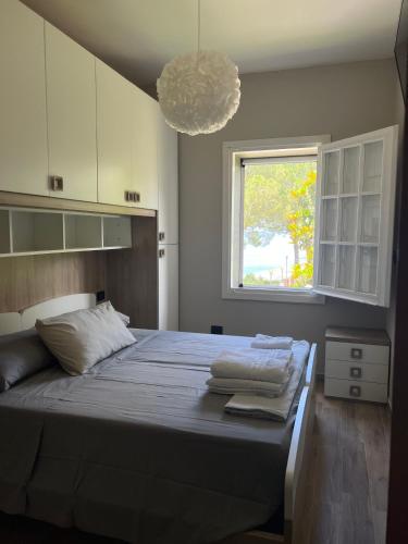 a bedroom with a large bed with towels on it at Villa Cataleya in Praia a Mare