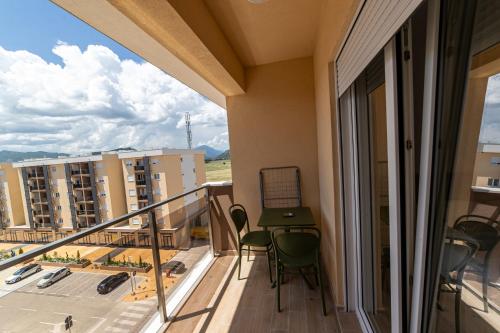 a balcony with chairs and a view of a building at Apart Kraft in Podgorica