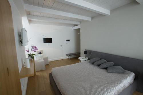 a bedroom with a bed with pillows on it at Villa Fornari Resort in Bisceglie