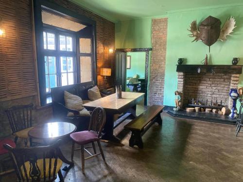 魯辛的住宿－里辛城堡Spa鄉村民宿，客房设有桌椅和壁炉。