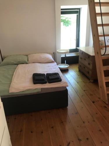 a bedroom with a bed and a wooden floor at Gemütliche Ferienwohnung an der Elbe in Bleckede