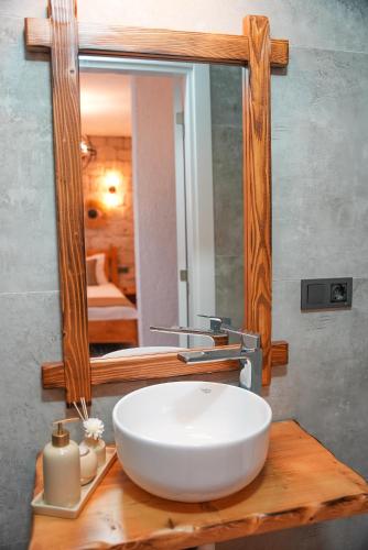 a bathroom with a white sink and a mirror at Armi Alaçatı in Cesme