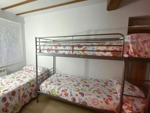 a bedroom with two bunk beds and a bed at Cantabria Collection - Espectacular casa con piscina y jardín in Oruña