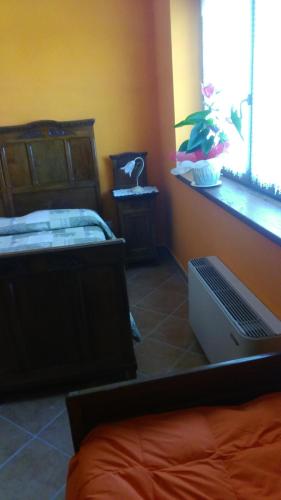 a bedroom with a bed and a laptop on the floor at il Balcone sul Monferrato in Tonco