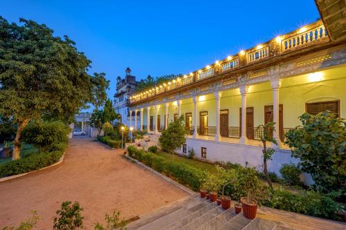 a building with lights on the side of it at Neemrana's - Piramal Haveli in Bagar