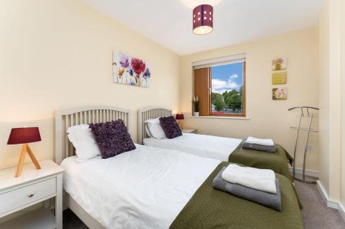 a bedroom with two beds and a window at Apartment 144 - Clifden in Clifden