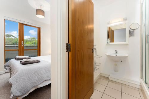 a bedroom with a bed and a sink and a toilet at Apartment 144 - Clifden in Clifden