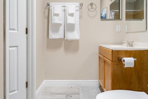 a bathroom with a sink and a toilet at Jacksonville Retreat: Unwind in Style at our Cozy Duplex Apartment in Jacksonville