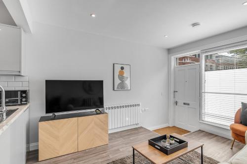 a living room with a tv and a couch at Surrey Street Duplex in Norwich