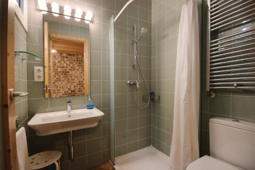 a bathroom with a sink and a shower and a toilet at B&B Sant Pol - Adults Only in San Pol de Mar