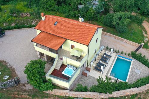 an overhead view of a house with an orange roof at Holiday Home Tos in Risika