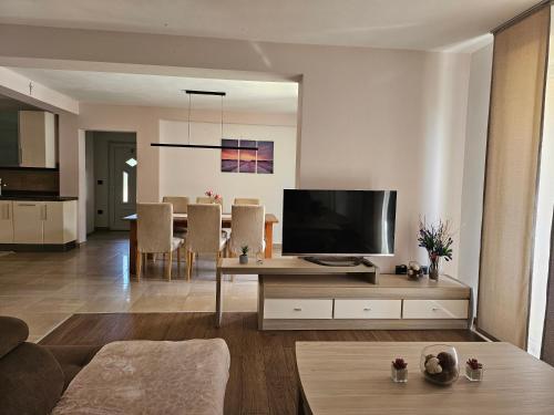 a living room with a television on a table at Premium Apartments Tade Funtana in Funtana